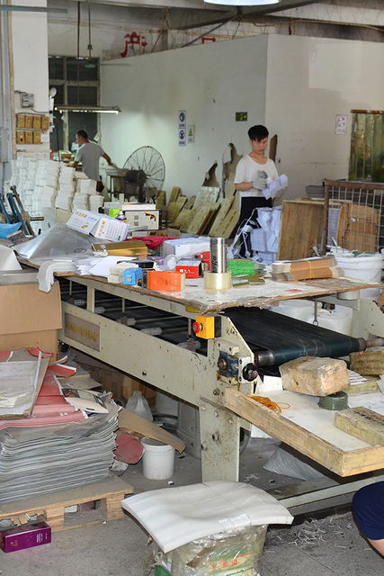 Production line at MC Packaging with employees crafting custom perfume boxes